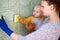 A mother with her little son is cleaning the house. The concept of combining homework and raising a child