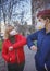 Mother and her millennial daughter wearing in respirators greeting each other with new rules