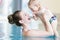 Mother and her newborn child at infant swimming class