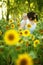 Mother with her son in the field with sunflowers