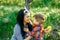 Mother and her son having fun outside in summer hugging and laughing.