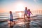 Mother with her sons playing on the shore