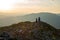 Mother and her teenage daughter are standing on a stony ridge