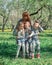 Mother with her three children, on a swing garden