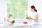 Mother and her toddler daughter cooking healthy salad