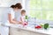 Mother and her toddler daughter washing vegetables