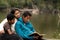 Mother with her Two Boys Studying the Bible by River Front