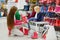 Mother and her two girls choosing new rain boots