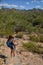 Mother hiking with child in southwest and showing him the cactus