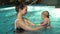 Mother hold baby in the pool