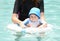 mother holding baby in pool at swim lesson for drowning prevention and water safety
