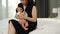 Mother holding and consoling her crying newborn baby in arms on bed