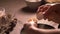 mother holding daughter\'s hand, guiding and teaching how to make dough for cookies by cracking egg in a bowl, close up