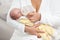 Mother holding and feeding newborn baby with milk bottle. Intimate moment between mom and baby