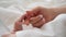 Mother holding hand of newborn baby