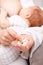 Mother holding handful of medicine while breastfeeding newborn baby