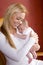 Mother holding newborn baby in rocking chair