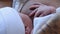 Mother Holding Newborn in Embrace and Breastfeed Her Infant, Close-up View of Baby Head, Tenderness and Care of Motherhood.