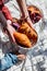 Mother holding a plate with croissants near son foot