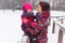 Mother holds daughter in park