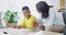 Mother, homework and student help in home with school paper, child and studying together in living room. Learning