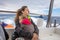 Mother hugging her daughter in motorboat sailing in ocean