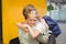 Mother hugging her daughter by school bus