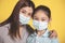 Mother hugs little daughter in protective medical masks during Covid-19 pandemics