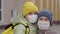 mother hugs little schoolgirl with backpack and with medical mask on her face, the 2019 covid virus, getting an