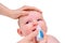 Mother instills nasal drops in Infant baby, face close-up, isolated on a w