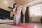 Mother and kid daughter doing yoga exercises on floor in room at home. Family having fun indoors with fitness. self-isolation in