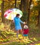 Mother and kids in autumn park. Family in rain