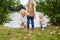 Mother and kids collecting leaves