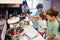 Mother with kids cooking at kitchen, happy children`s moments