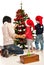 Mother with kids decorate tree