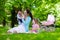 Mother and kids enjoying picnic outdoors