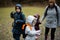 Mother with kids holding willow twigs while traveling in forest