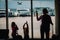 Mother with kids play toy planes in airport, family with luggage waiting