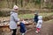 Mother with kids pour water from a stream and playing  at Znojmo park in Czech Republic