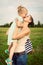 Mother kissing adorable smiling daughter