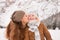 Mother kissing child outdoors among snow-capped mountains
