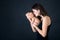 Mother kissing and hugging newborn son at gray background, tender, care, love