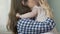 Mother kissing and hugging small kid, comforting soothing movements, upset child