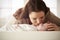 Mother Kissing Newborn Baby Lying On Changing Table In Nursery