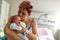 Mother kissing newborn son - Portrait of beautiful woman and lit