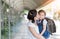 Mother kissing schoolgirl in uniform.