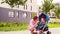 Mother kissing son eating chocolate in stroller