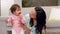 Mother kneeling on floor holding her baby