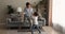 Mother and little adorable daughter dancing in living room
