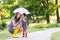 Mother and little adorable toddler daughter in yellow rubber boo